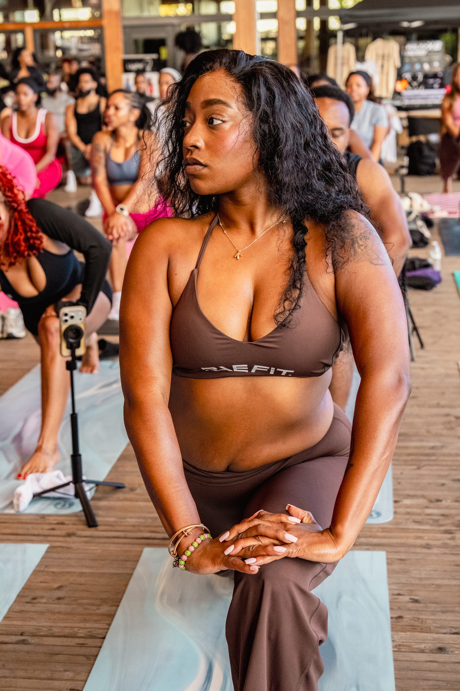 Participant in brown Raefit kneeling, serene and focused