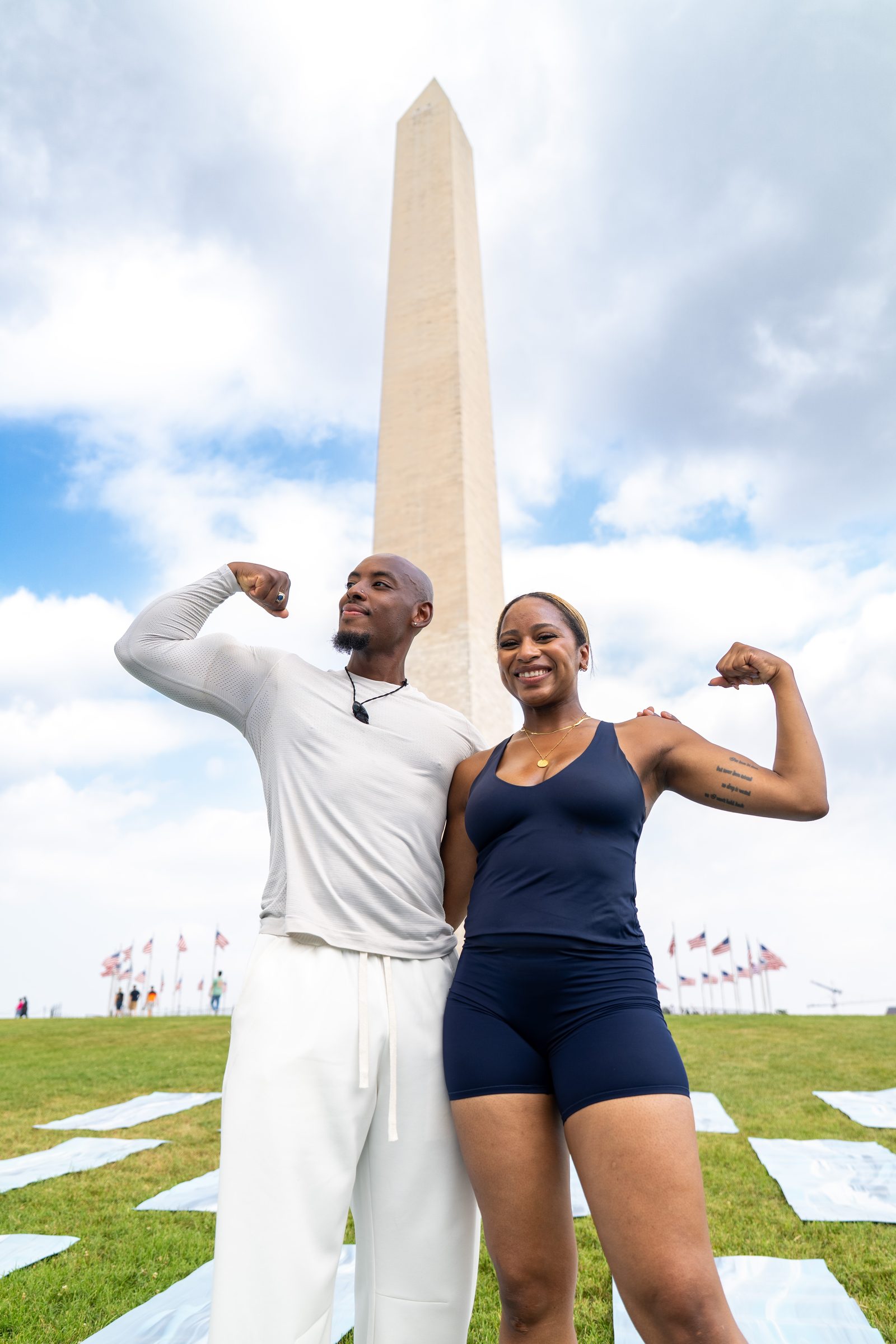 Two founders flexing in front of the Washington Monument